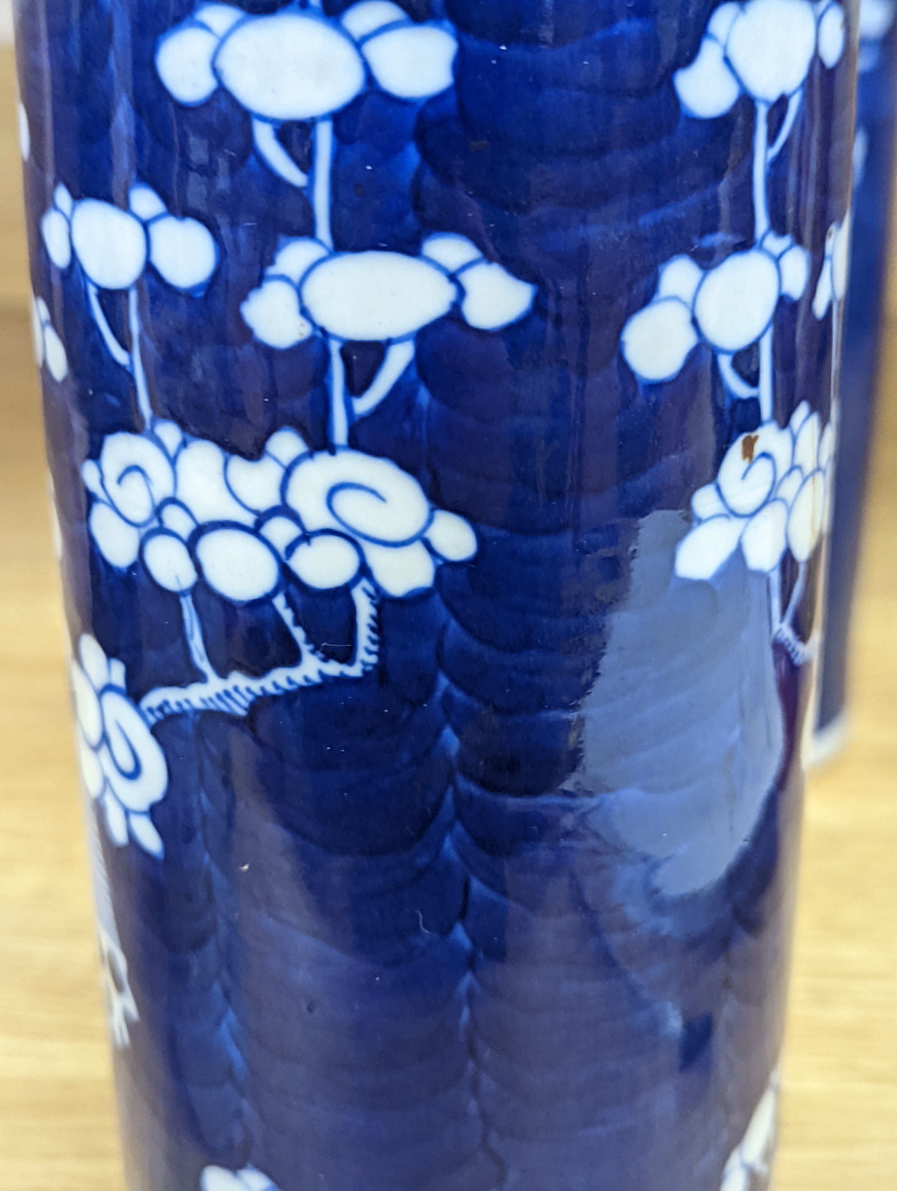 An 18th century Chinese famille rose mug, a Chinese Imari tea caddy and two Chinese blue and white sleeve vases 30cm (4)